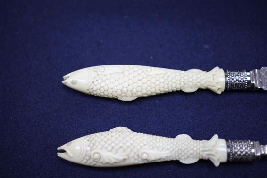 A cased small pair of Victorian carved ivory handled and silver fish servers, knife 9.75in.